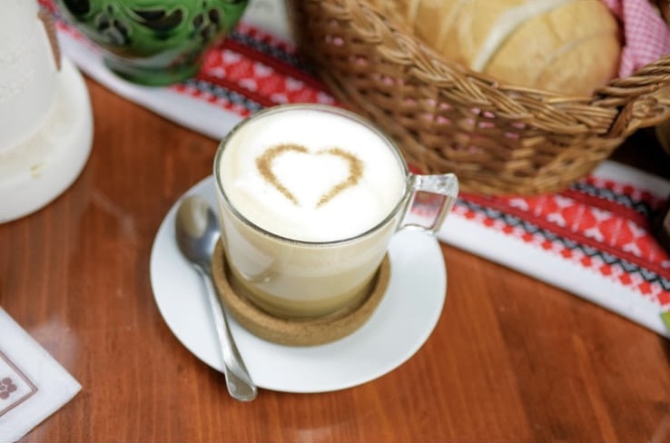 Hot coffee topped with foam in a mug
